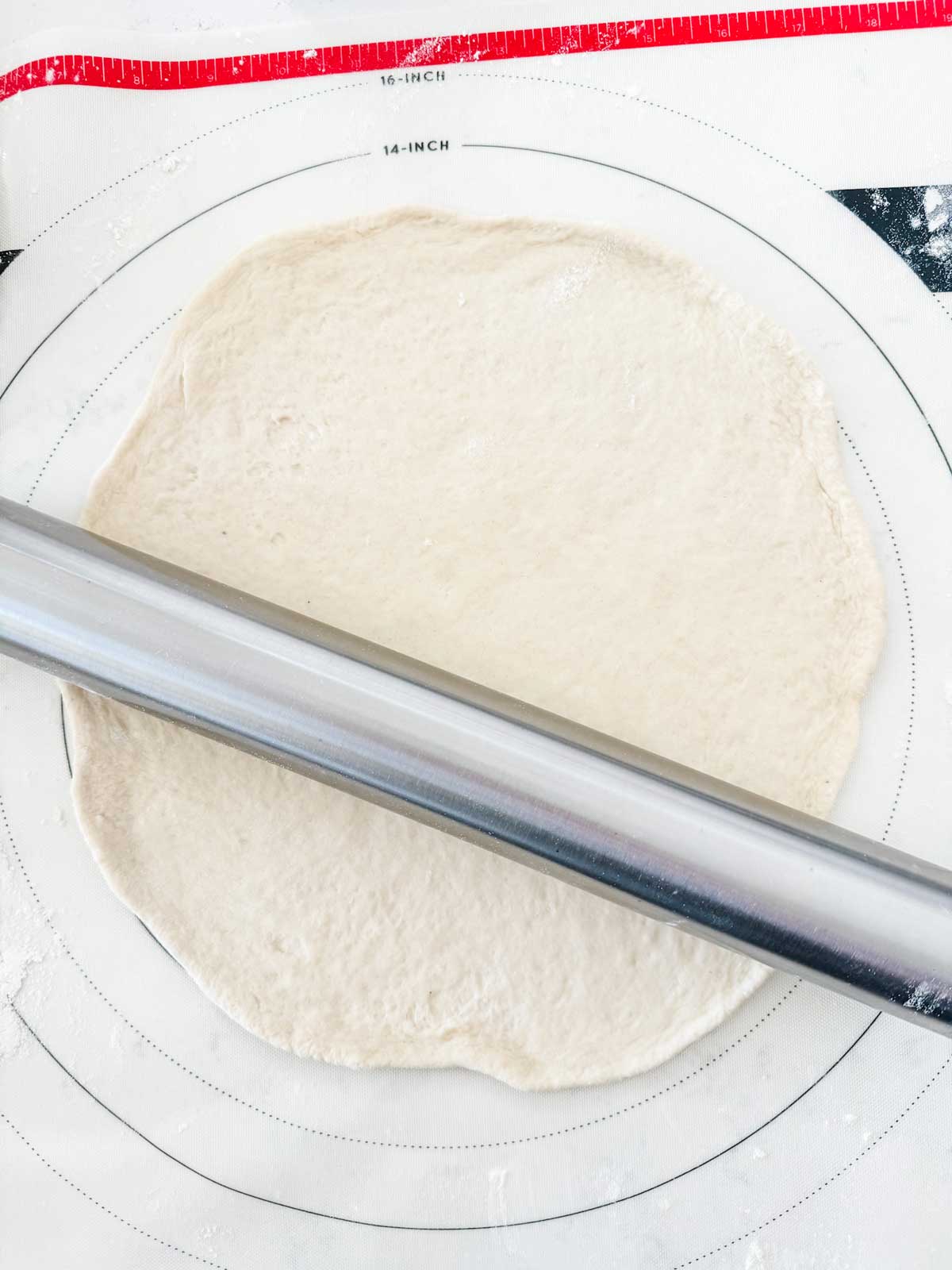 Photo of a rolled out pizza dough.
