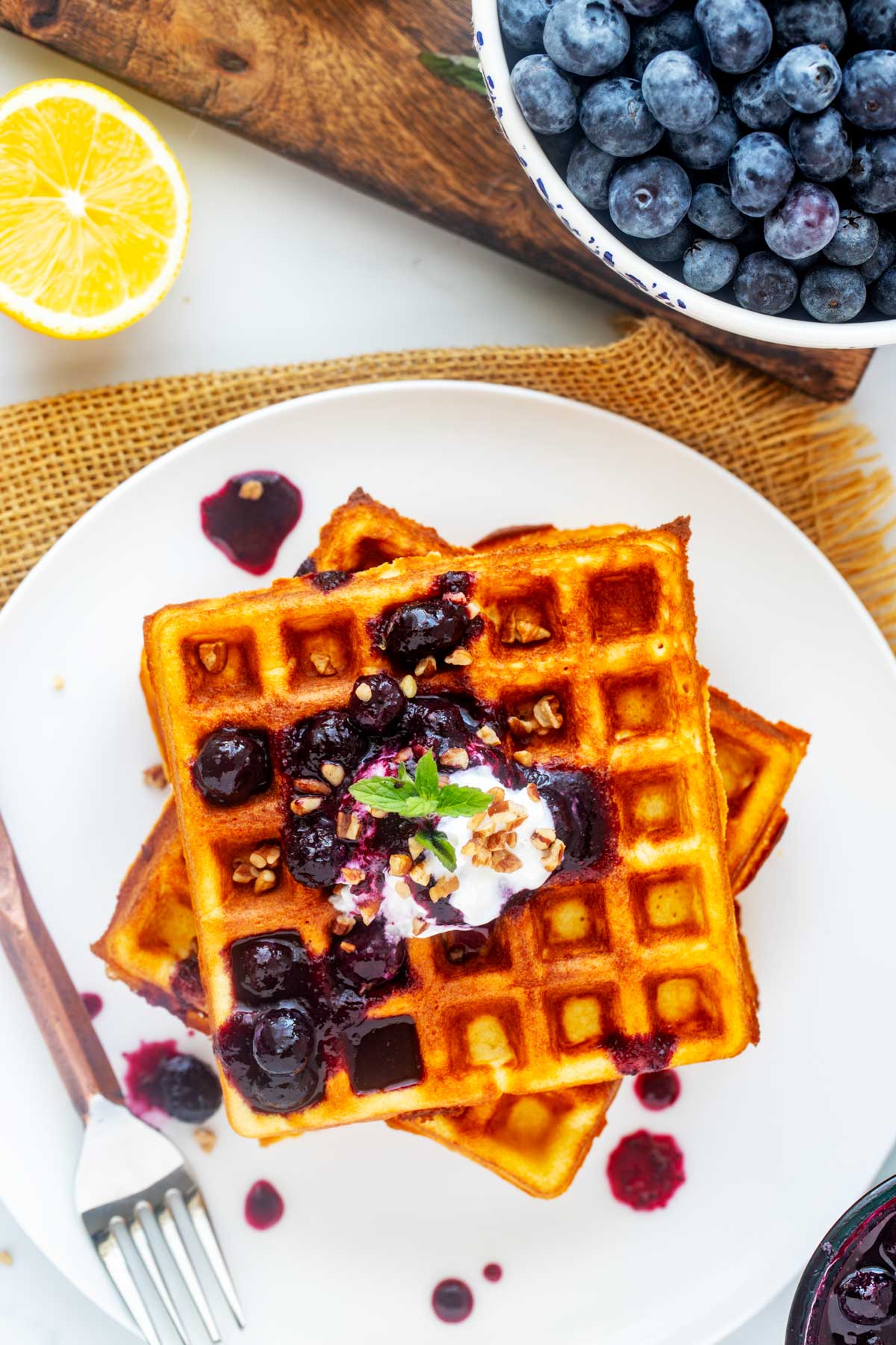 Overhead photo of a white plate with high protein waffles on it.