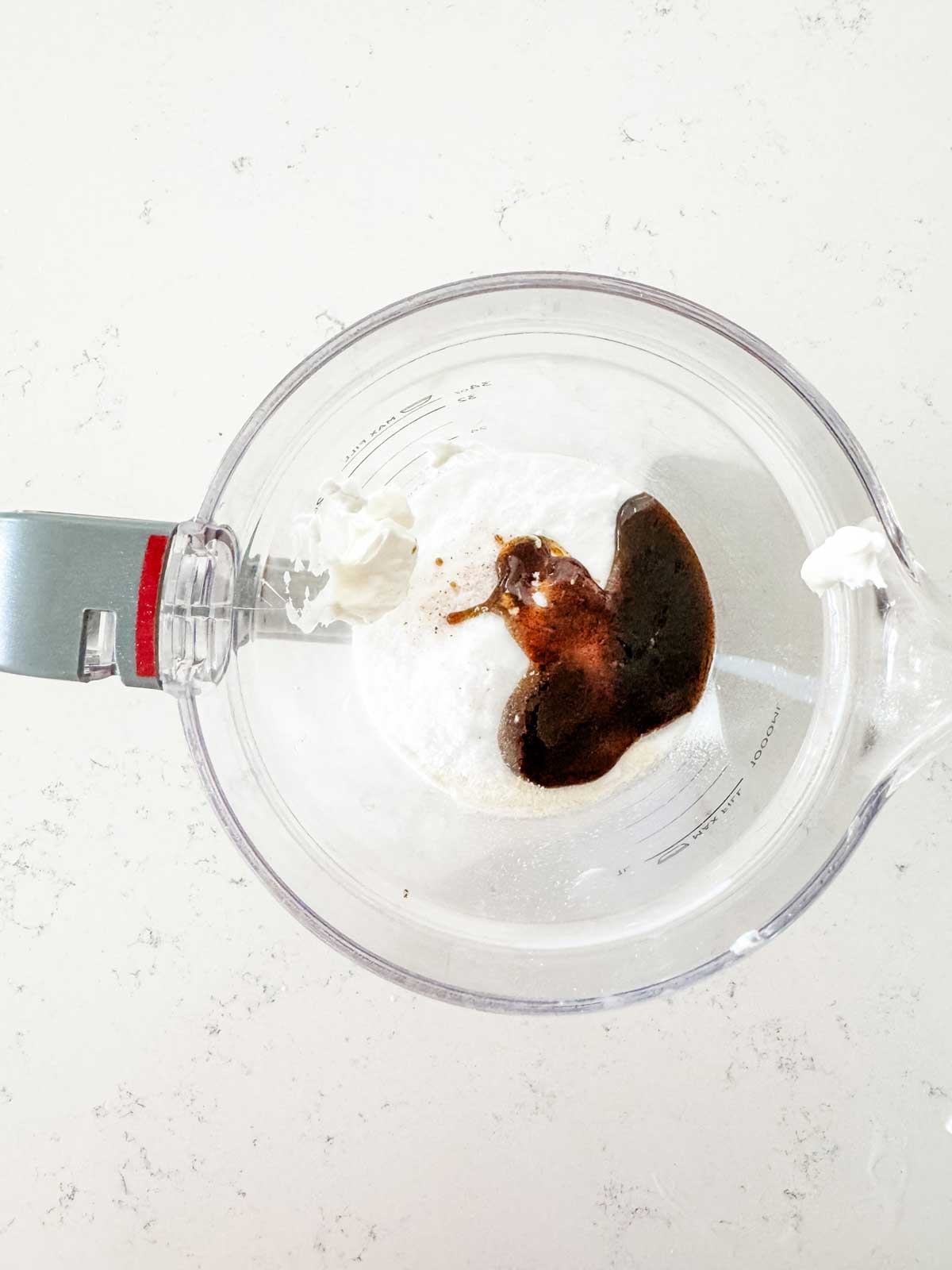 Milk, yogurt, protein powder, vanilla bean paste, allulose and salt in a blender.