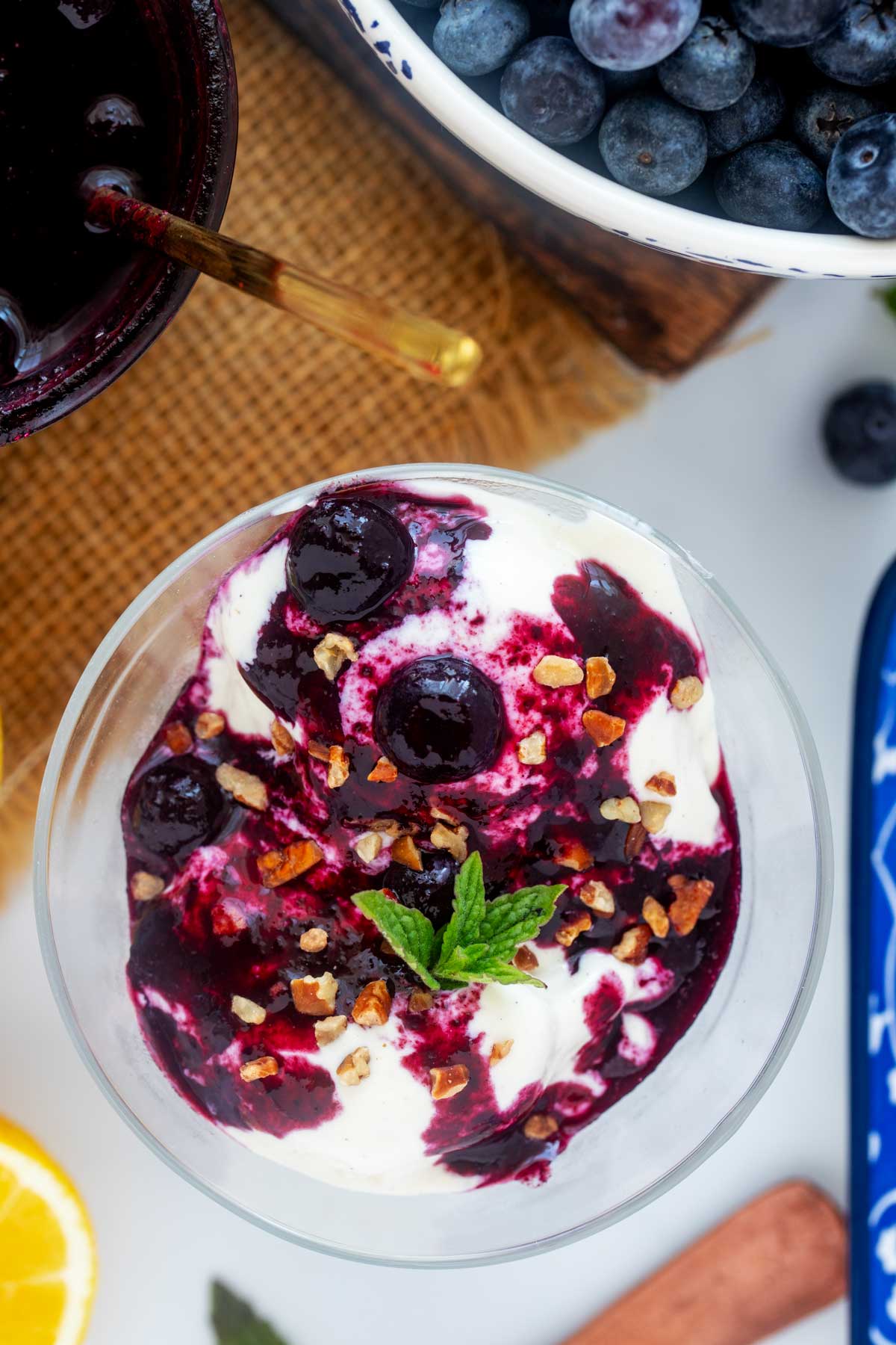 Overhead photo of an ice cream dish with NInja Creami Protein Ice cream topped with blueberry compote.