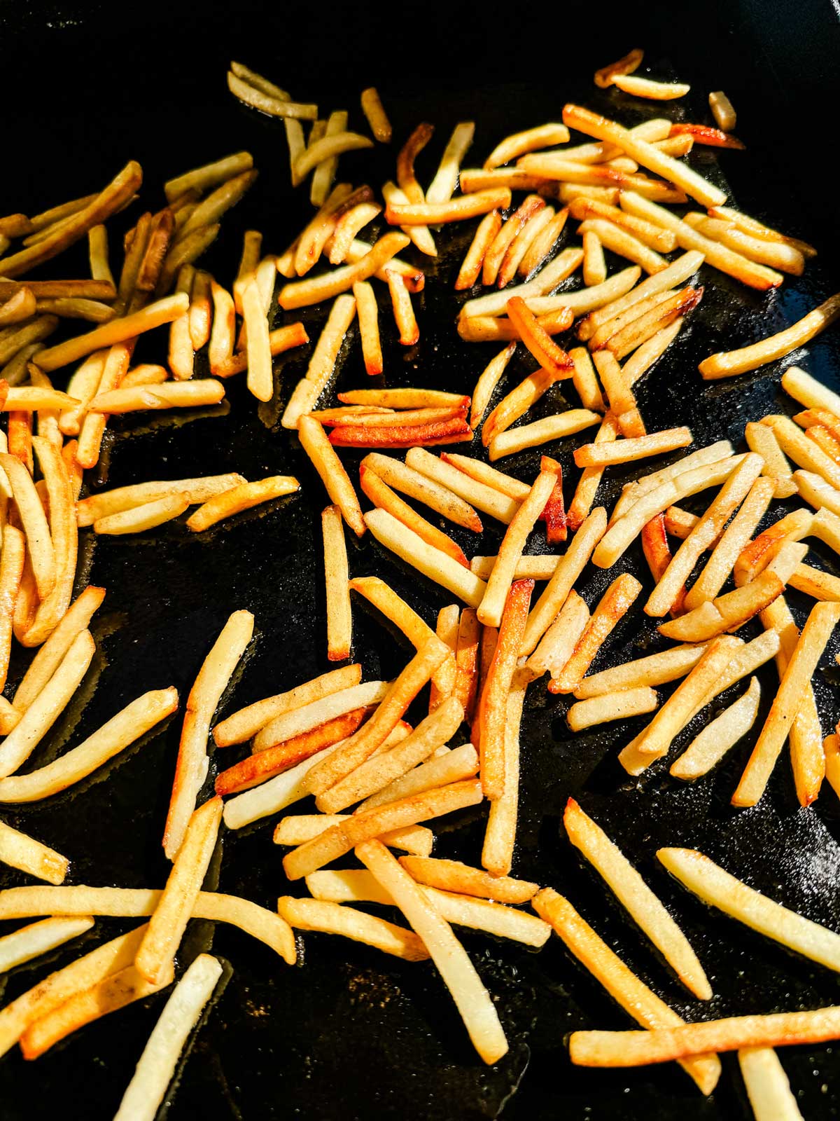 Overhead photo of french fries on a Blackstone griddle.