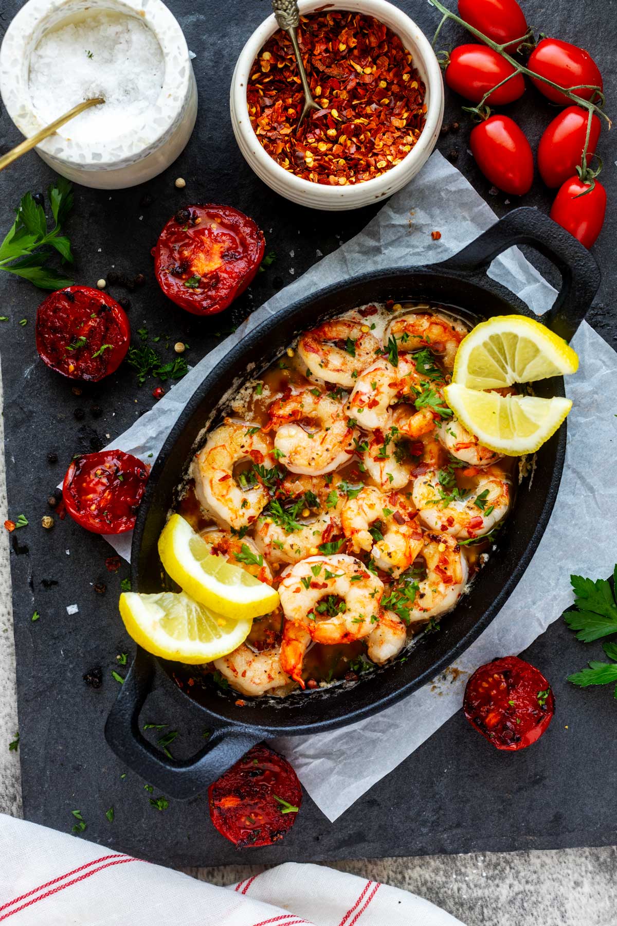 Overhead photo of a small cast iron pan with Blackstone shrimp in garlic butter.