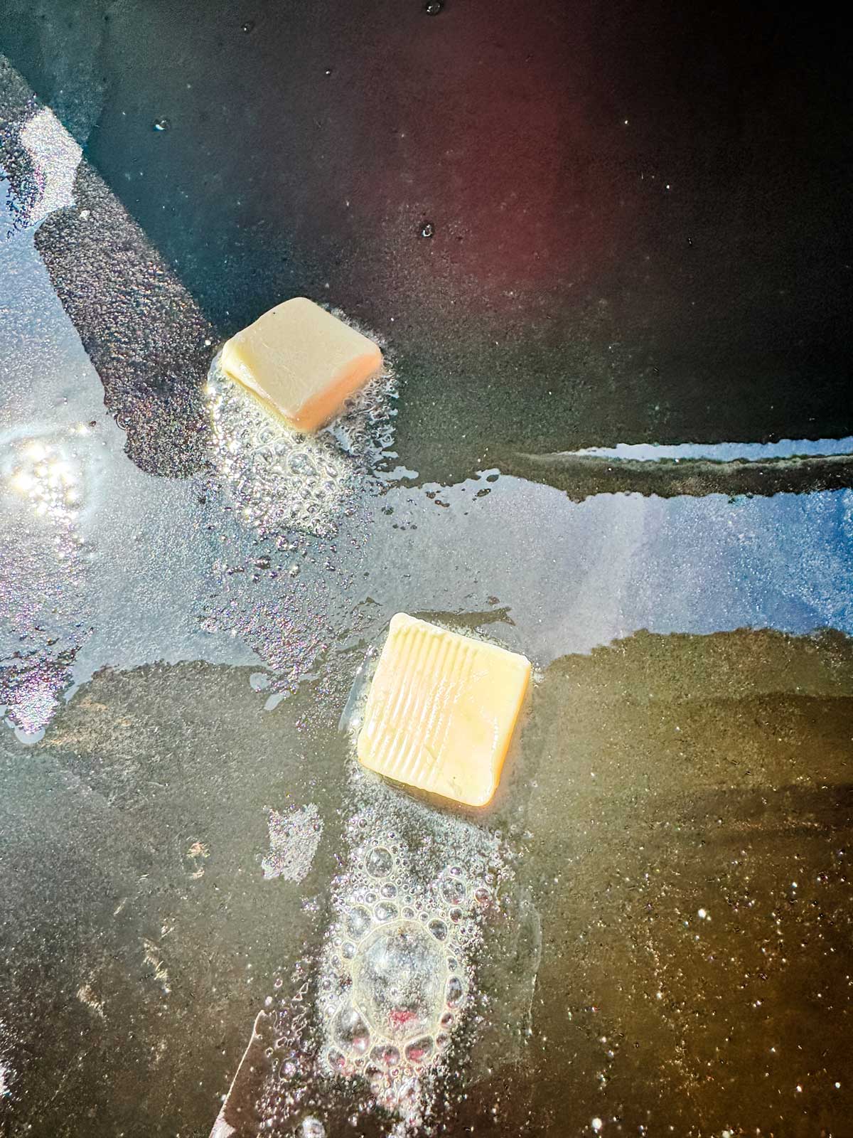 Photo of melting butter on a Blackstone griddle.