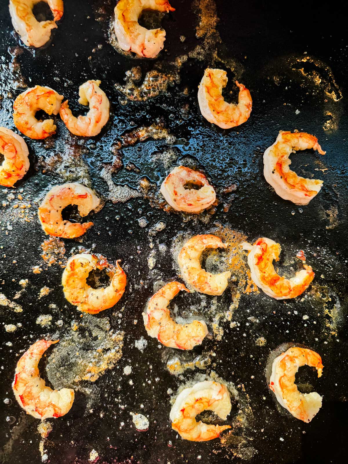 Shrimp cooking on a Blackstone griddle.
