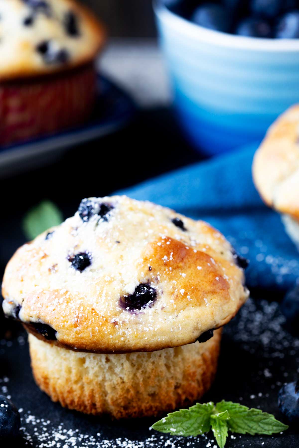 Close up side photo of a buttermilk blueberry muffin.