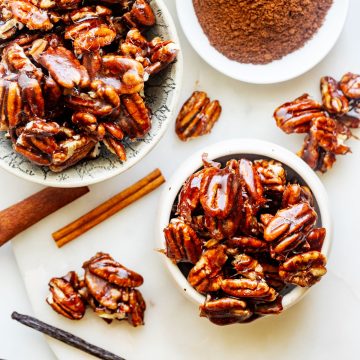 Overhead square photo of a small and medium bowl with candied spiced pecans.