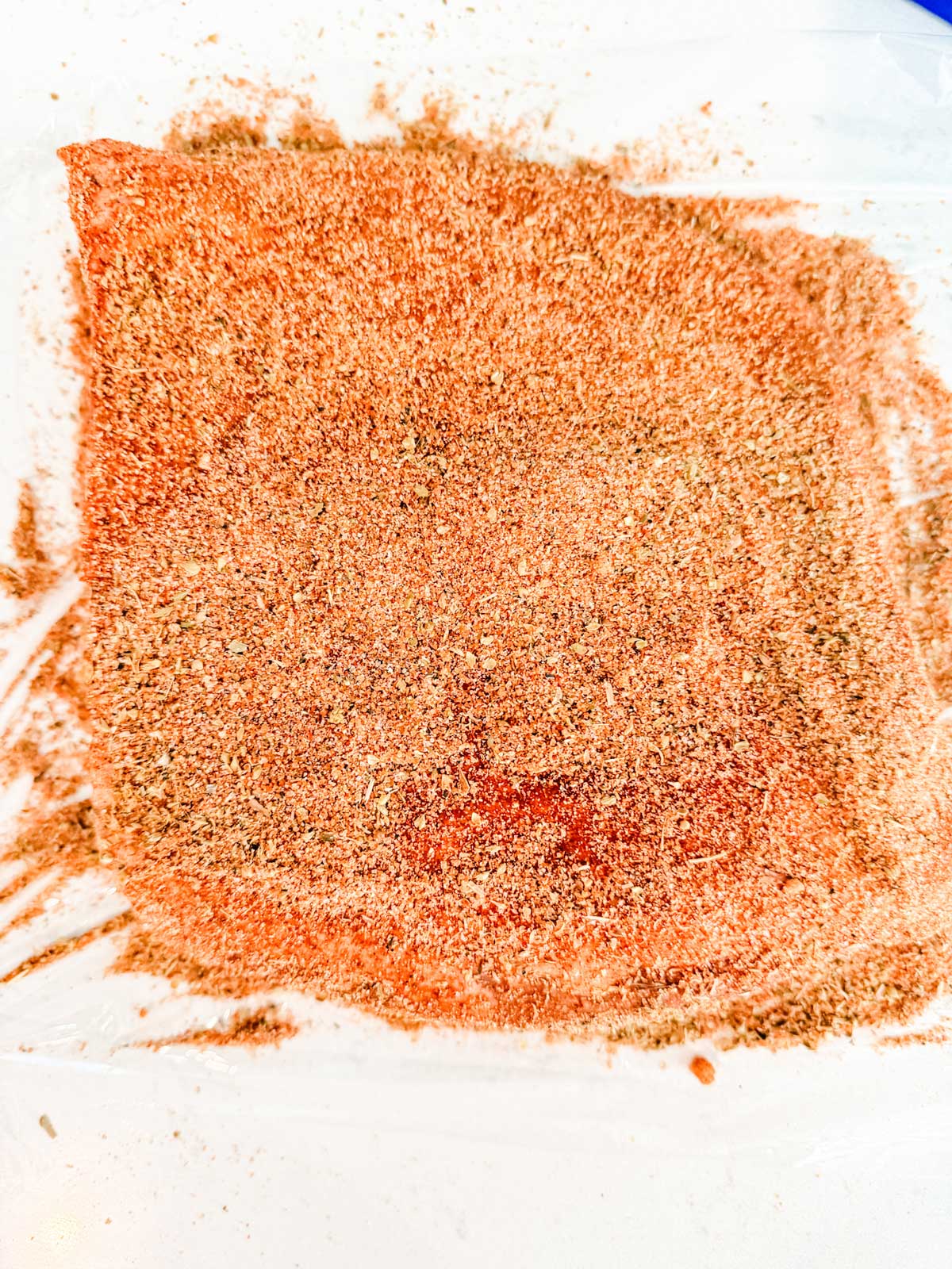 A brisket heavily coated with seasonings.